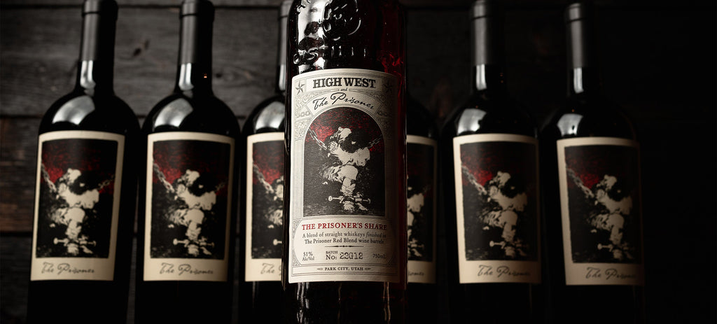 bottle of the prisoners share whiskey with the prisoner red blend in background